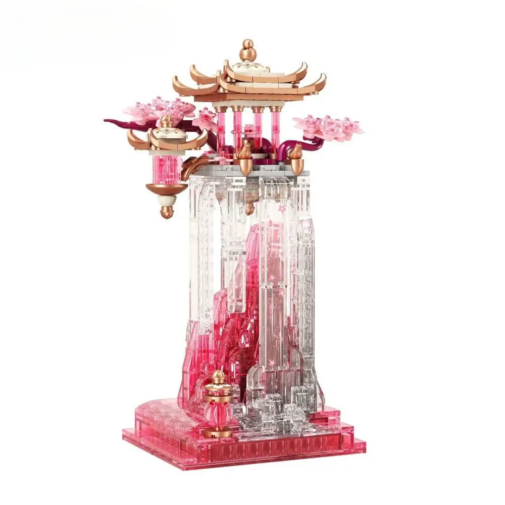 A translucent pink and clear glass fu yue dream glass yue pavilion ornament with gold accents and cherry blossom details