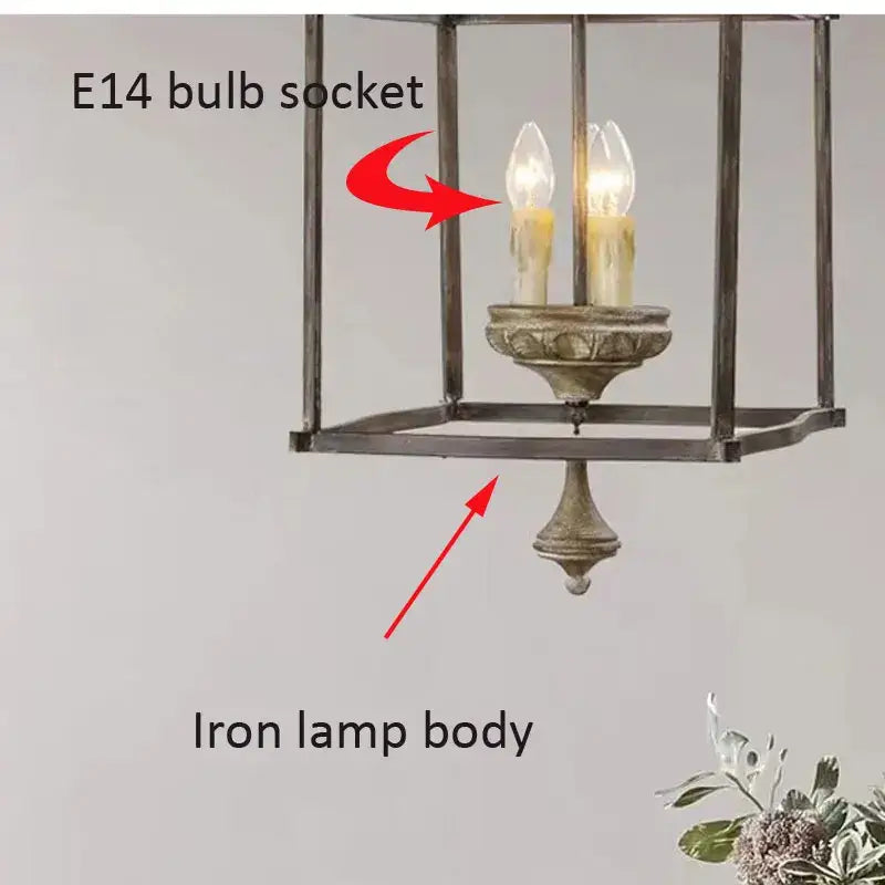 Antique american iron e14 chandelier with distressed metallic finish featuring two lit candle-shaped bulbs for dining room decorbites american iron