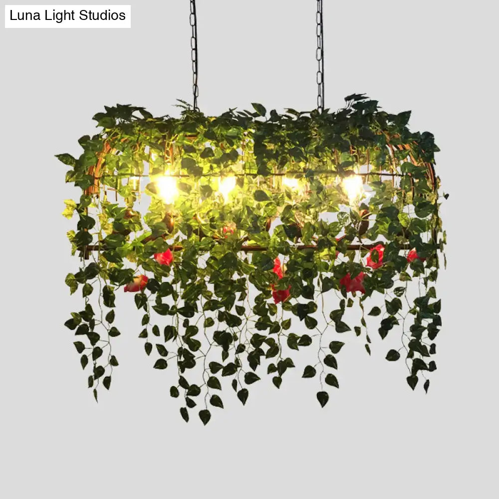 DecorBites antique black metal island chandelier with hanging vines red flowers and warm glowing lights for restaurants
