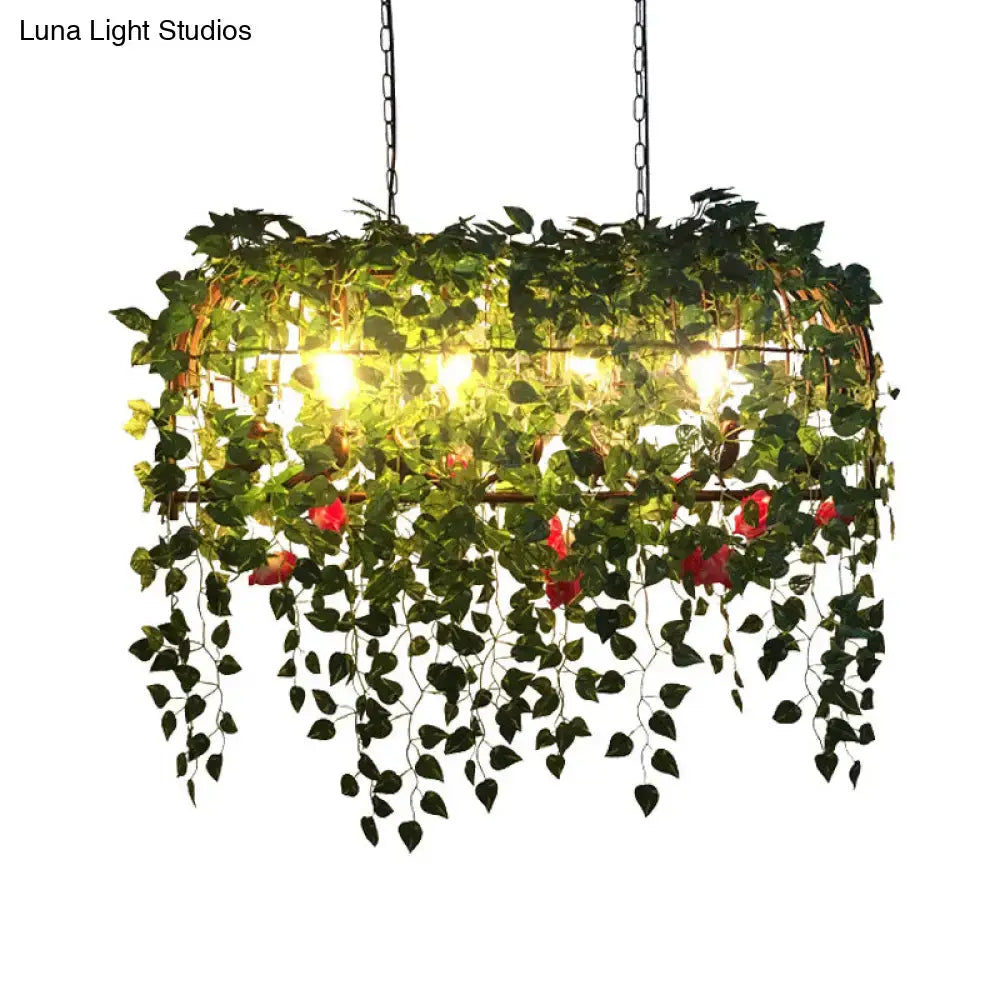 Decorbites™ antique black metal island chandelier with lush green vines and red flowers for restaurant decor