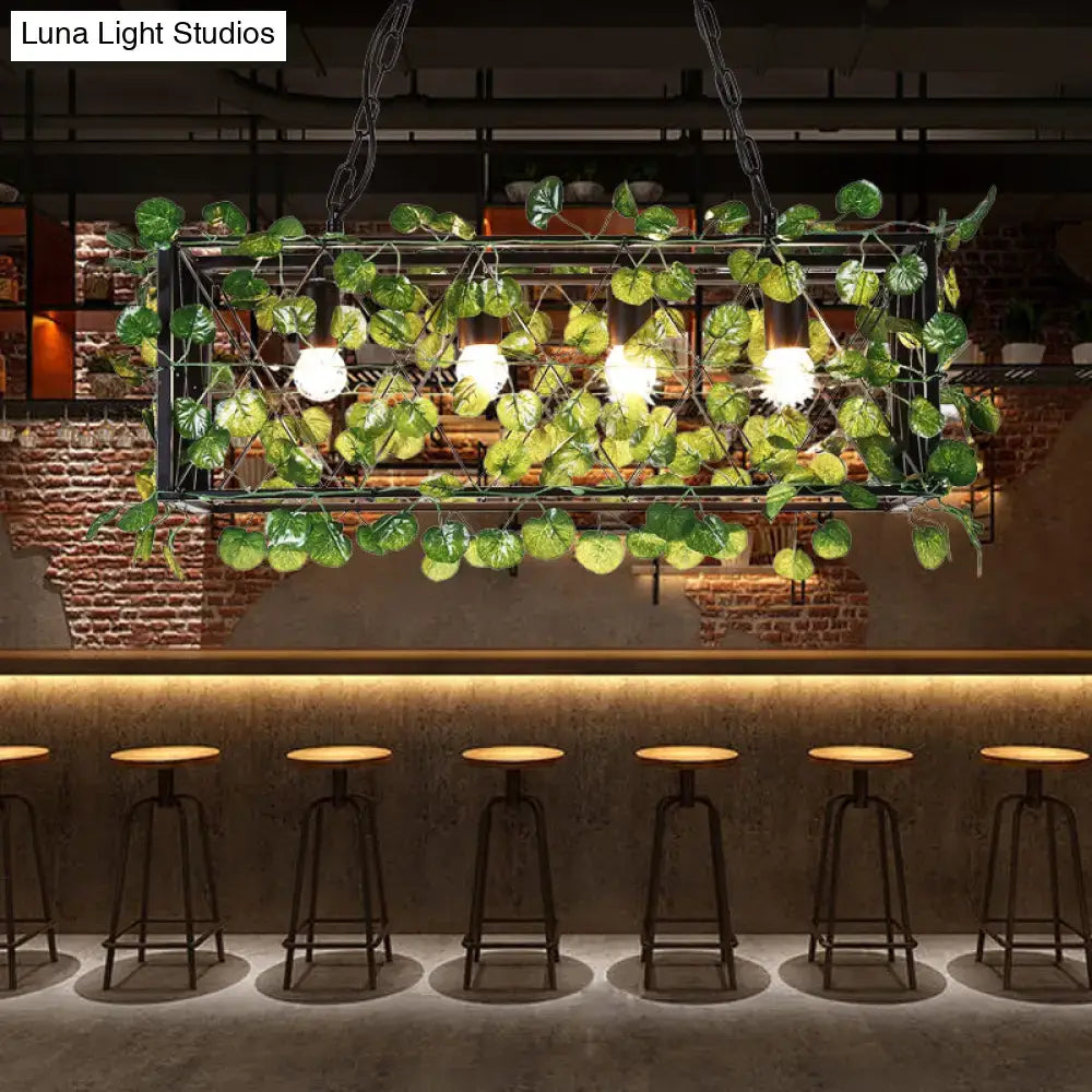 Decorbites metal island pendant in antique black metal frame with LED bulbs and green leafy vine plant decor