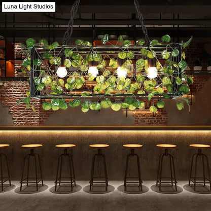Decorbites metal island pendant in antique black metal frame with LED bulbs and green leafy vine plant decor