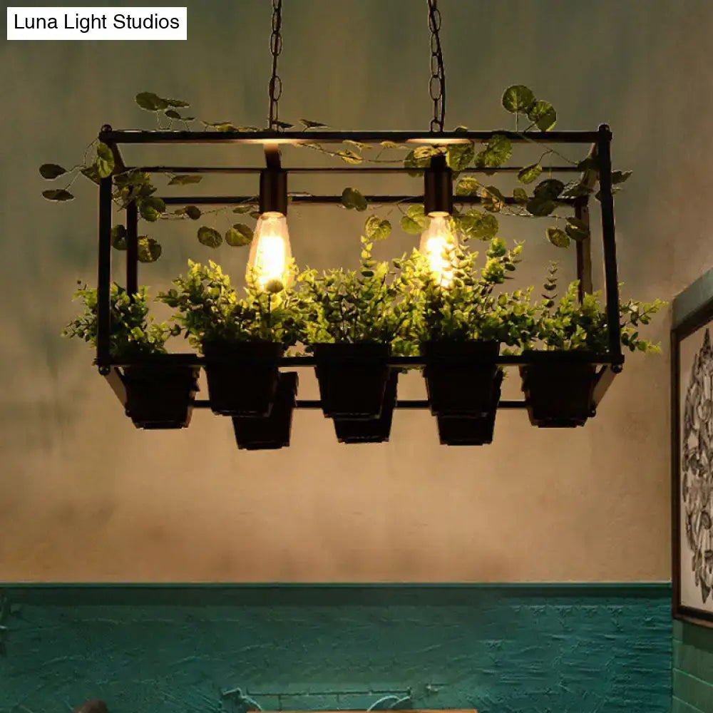 Industrial-style antique black metal hanging planter light fixture with three filament bulbs and five greenery planters