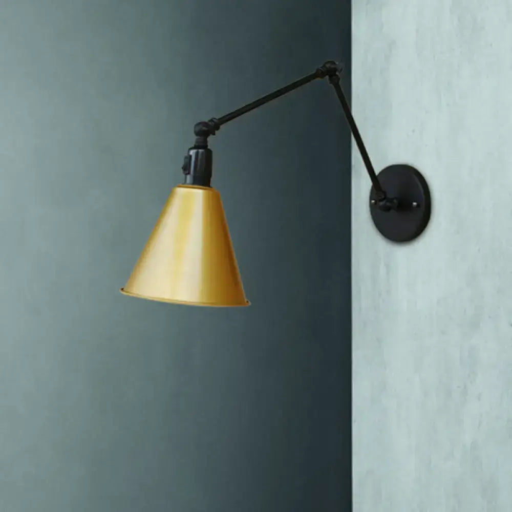 Gold-colored conical metal lampshade on black direct wired wrought iron articulated arm wall sconce by decorbites