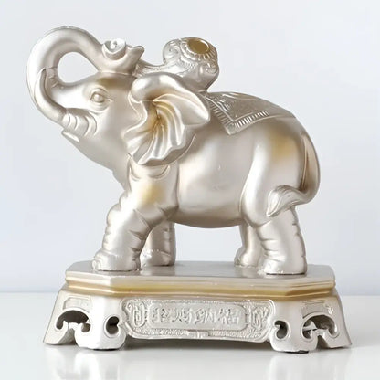 Silver elephant couple resin figurine with intricate detailing and golden accent on ornate base for living room decor