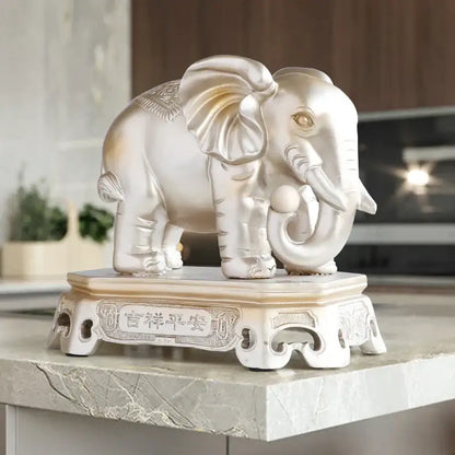 Silver elephant couple resin statue with gold accents on ornate white base engraved with chinese characters decorbites elephant couple decor
