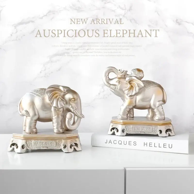 Silver metallic elephant couple resin figurines with intricate engravings and polished finish on ornate bases for decorbites decor