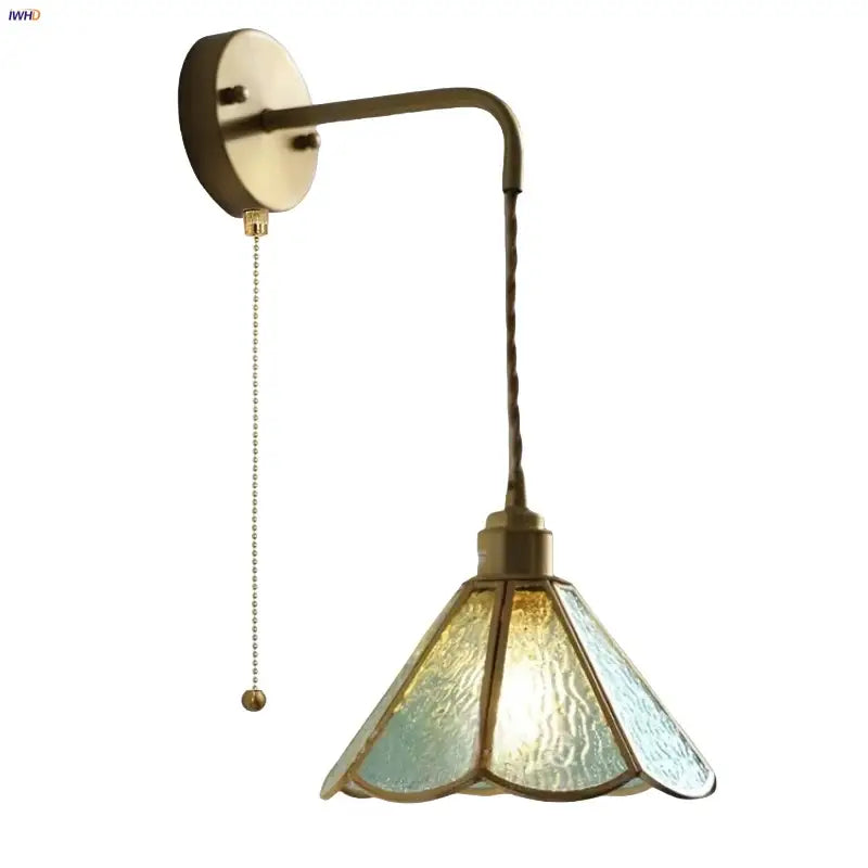 Antique brass-finished wall sconce with textured blue glass led shade and ornate twisted cord for decorbites blue glass lighting