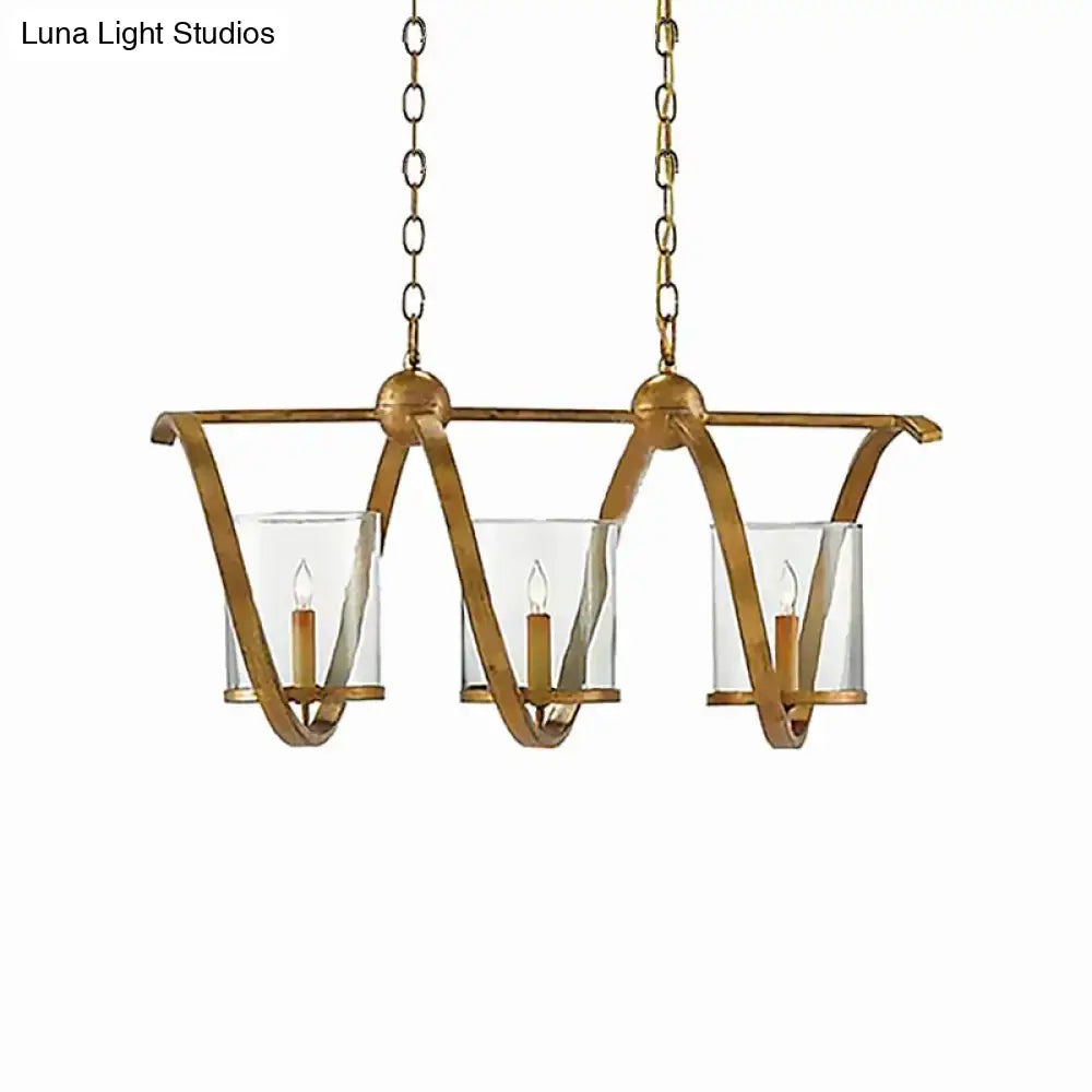 Gold-toned wrought iron chandelier with three clear glass candle holders and matching chains in antique brass for dining room