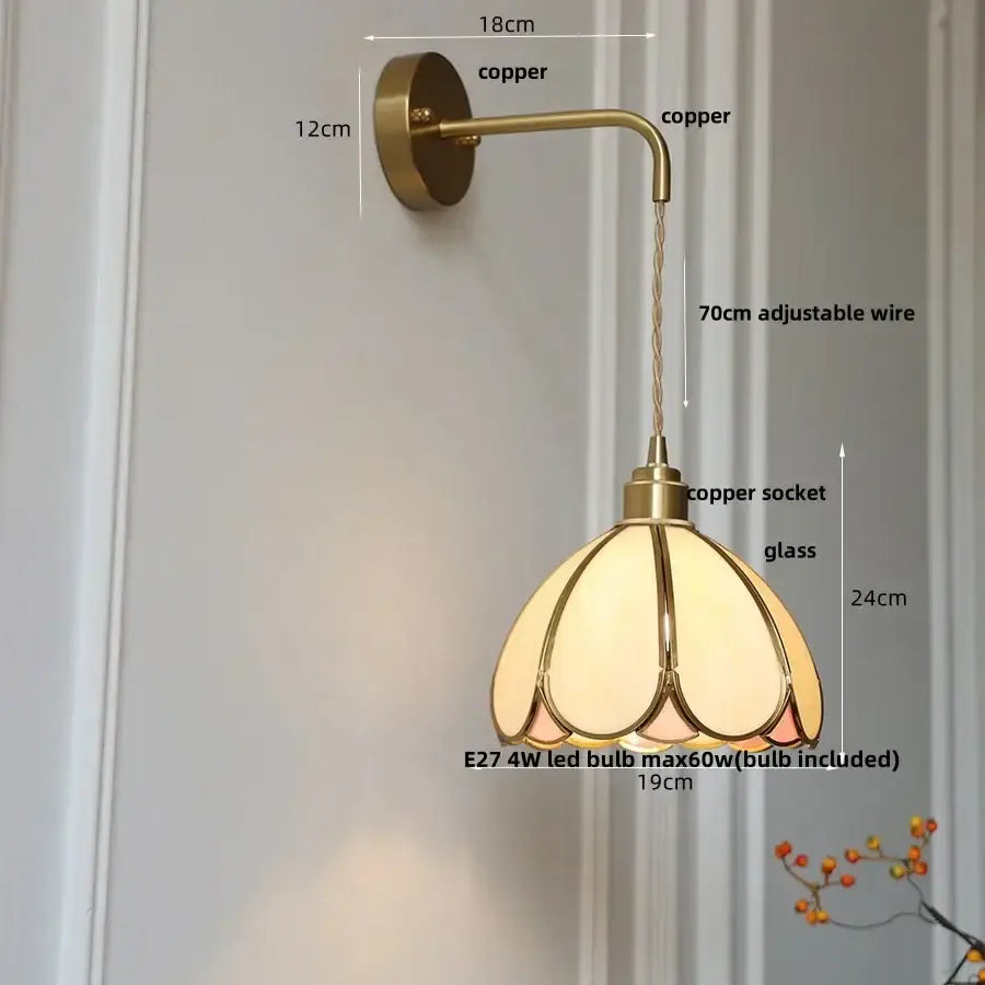 Antique brass wall light with a vintage copper sconce and decorbites amber glass led petal-shaped shade