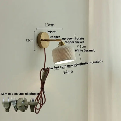 A sleek white ceramic led wall light with ribbed texture mounted on a polished antique brass and copper arm decorbites ceramic led