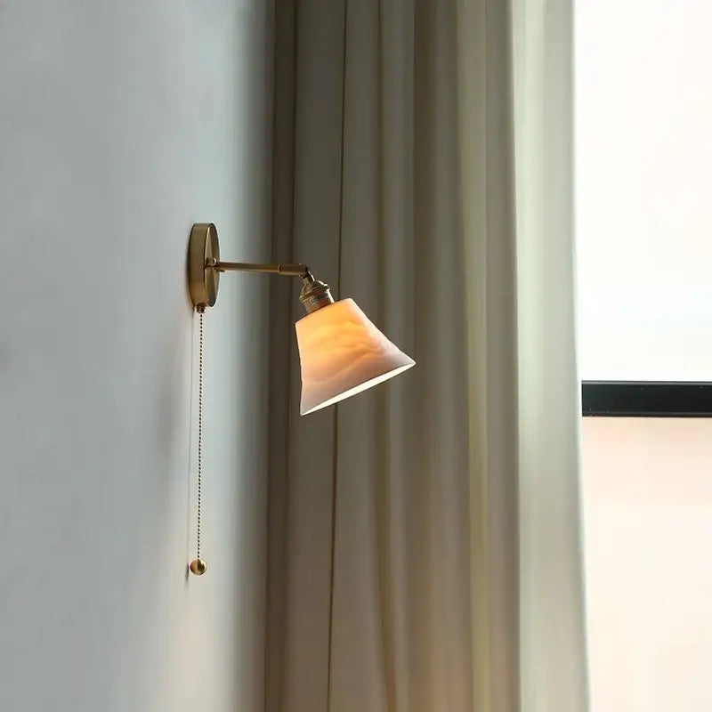 Antique brass wall light with adjustable arm and warm amber glass shade ideal for decorbites ceramic led wall use