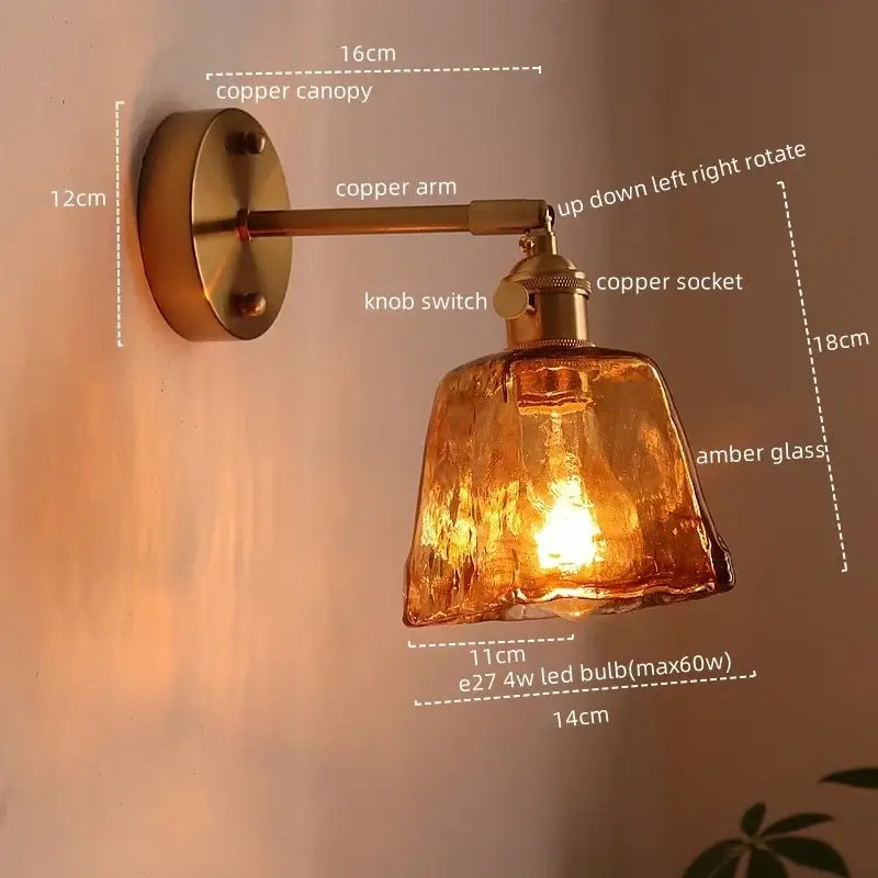 Copper-finished copper led wall light with textured amber glass shade for bedroom featuring antique brass accents