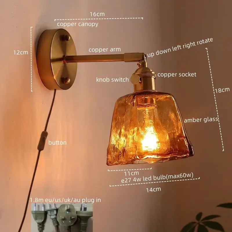Copper led wall light with amber textured glass shade and adjustable arm for bedroom wall lights in antique brass finish