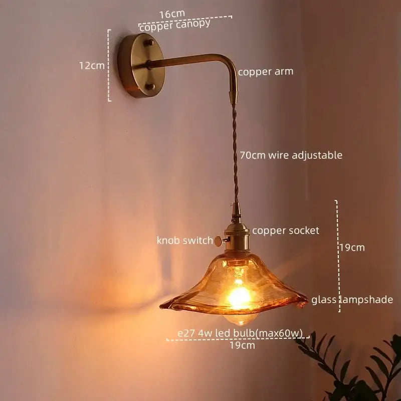 Copper led wall sconce with amber glass shade and adjustable wire arm perfect as antique brass wall lights for bedroom