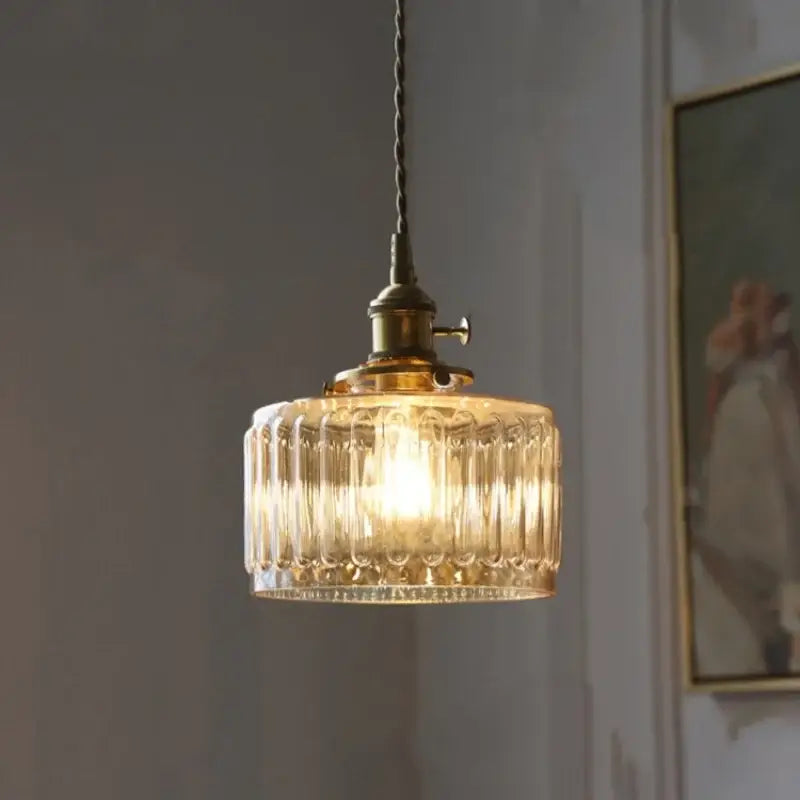 Antique brass and amber glass led pendant light with warm-toned ribbed glass and twisted cord for stairs lighting
