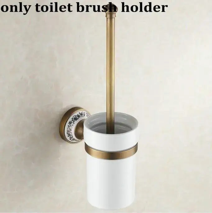 White ceramic toilet brush holder with gold-toned accents and floral mounting plate in decorbites bathroom accessories set