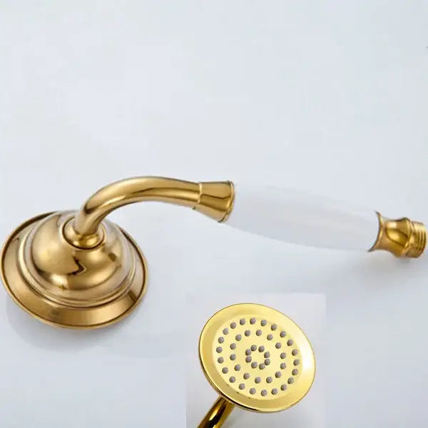 Gold-finished antique brass and chrome hand shower head with white ceramic handle and circular spray face