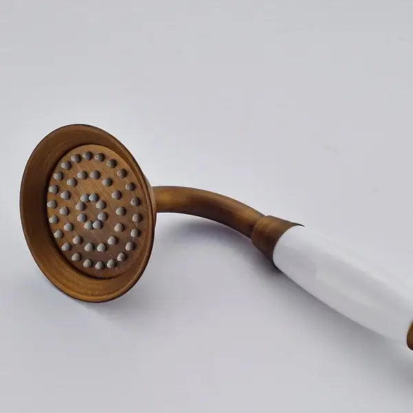 Antique brass and chrome hand shower head with white ceramic handle and multiple spray nozzles bathroom sprayer