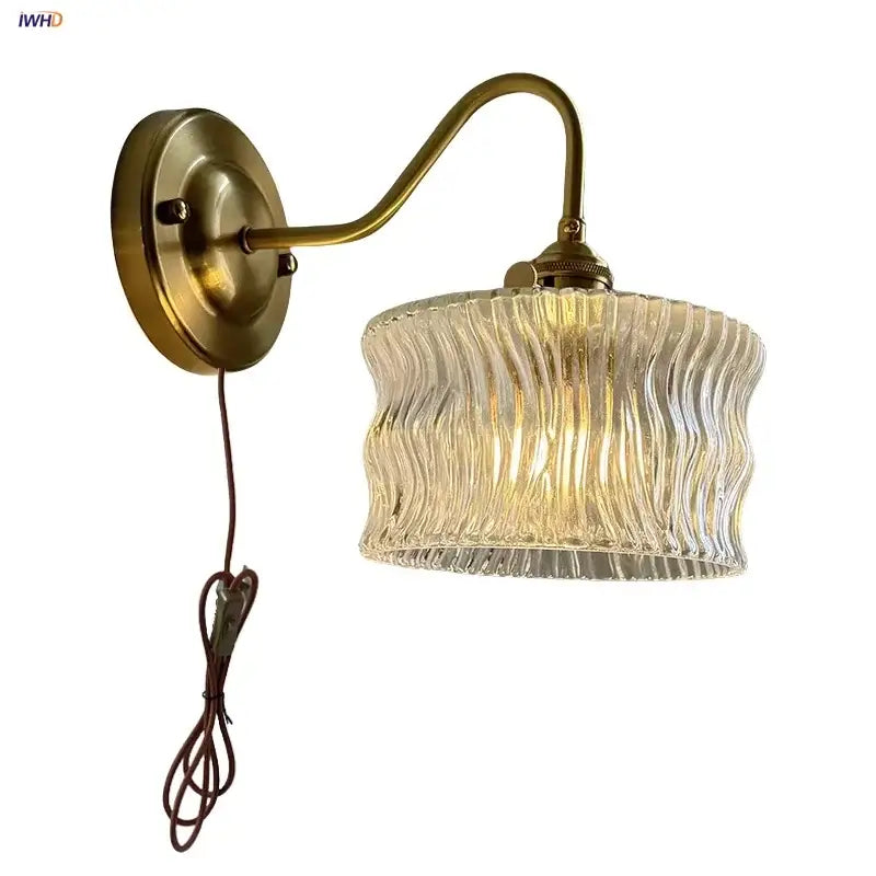 Antique brass wall sconce with clear glass wavy-textured shade for bedroom lighting decorbites clear glass design