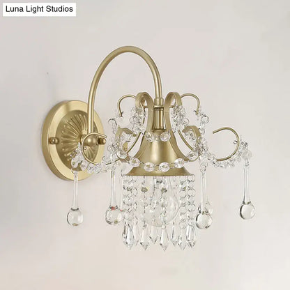Antique brass and crystal teardrop wall light sconce with cascading crystal droplets for elegant bedroom lighting