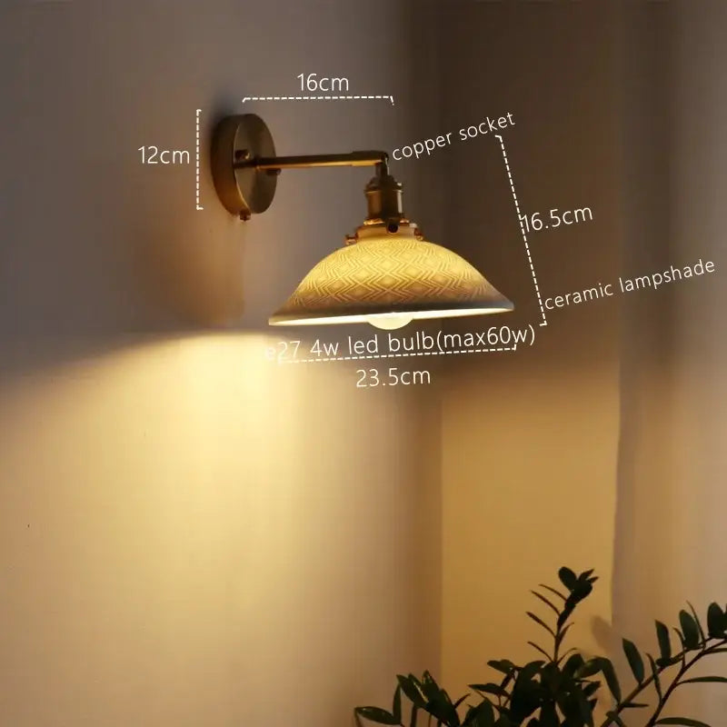 Antique brass wall lamp with a ceramic copper socket and amber ceramic copper led shade featuring etched patterns