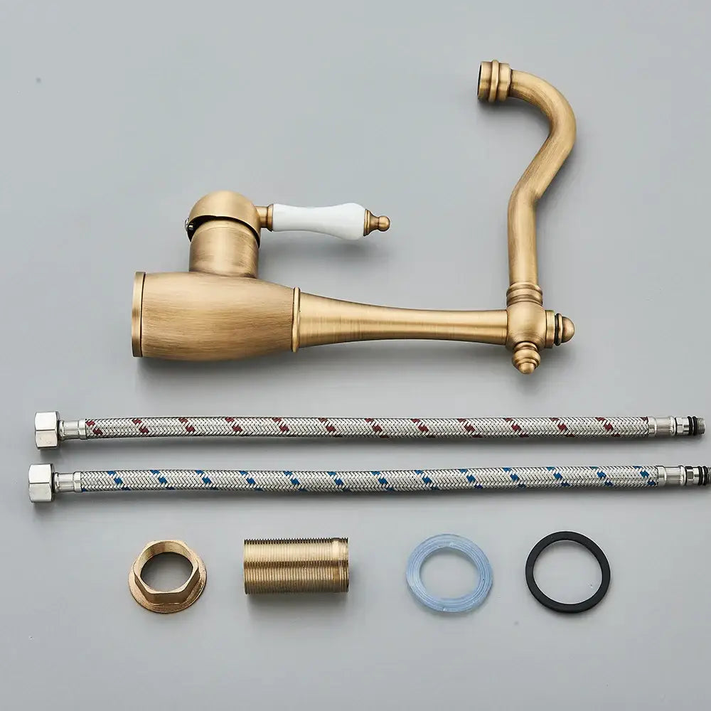 Antique brass and white ceramic basin waterfall faucet with ceramic handle and two braided metal hoses for kitchen use
