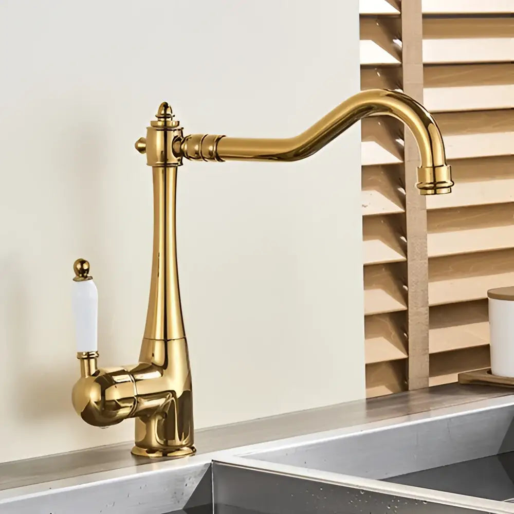 Antique brass basin waterfall faucet with gold finish curved spout and white ceramic handle for kitchen use