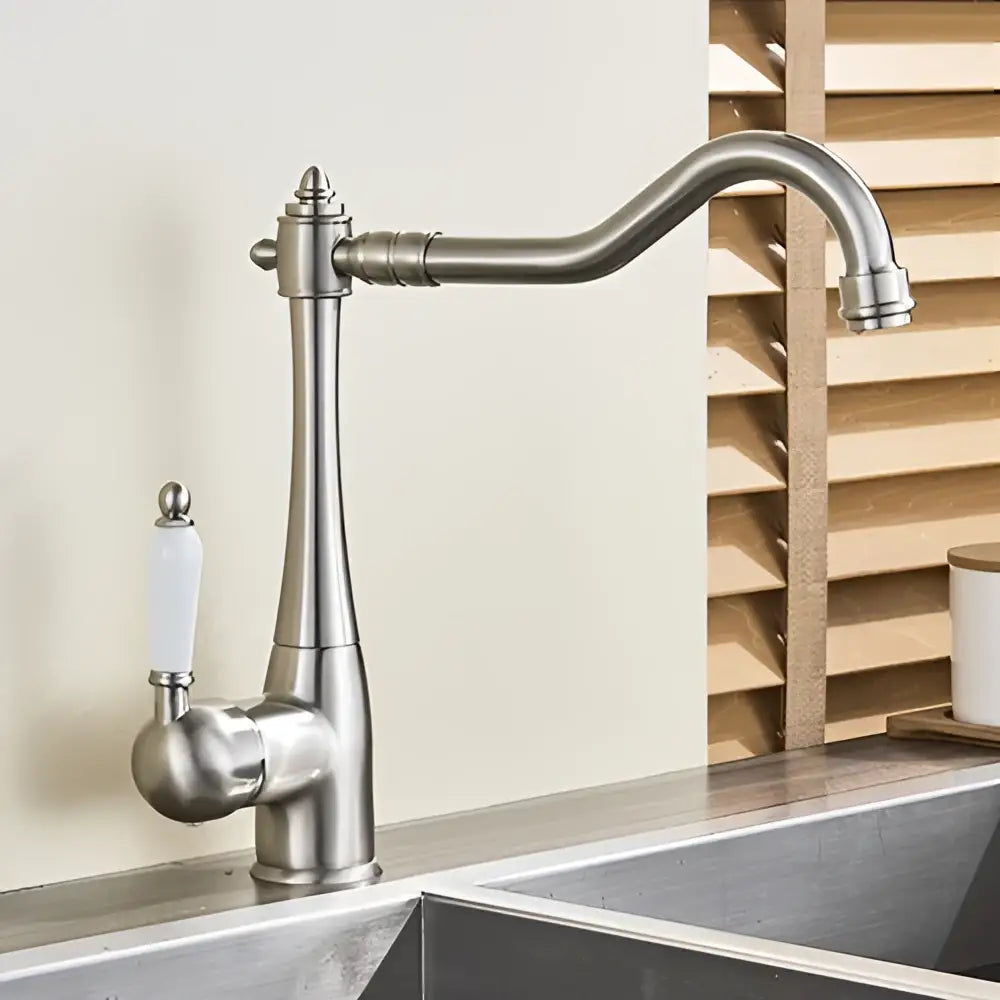 Stainless steel basin waterfall faucet with curved spout and white ceramic handle for kitchen use