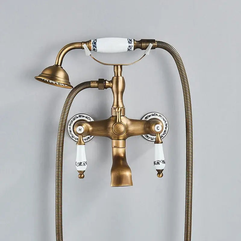 Antique brass and white ceramic bathtub shower faucet set with decorative blue floral patterns and ceramic handles