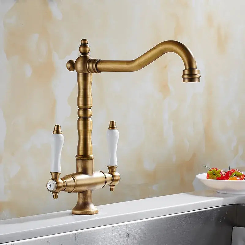 Antique brass and white ceramic kitchen faucet with swivel mixer curved spout and ceramic handles