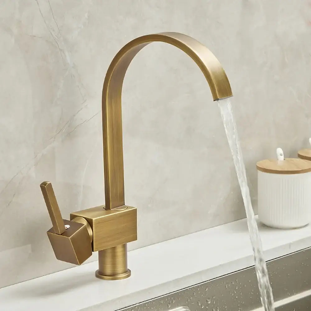 Antique brass and white ceramic kitchen faucet swivel mixer with brass-finished modern arched spout and square base