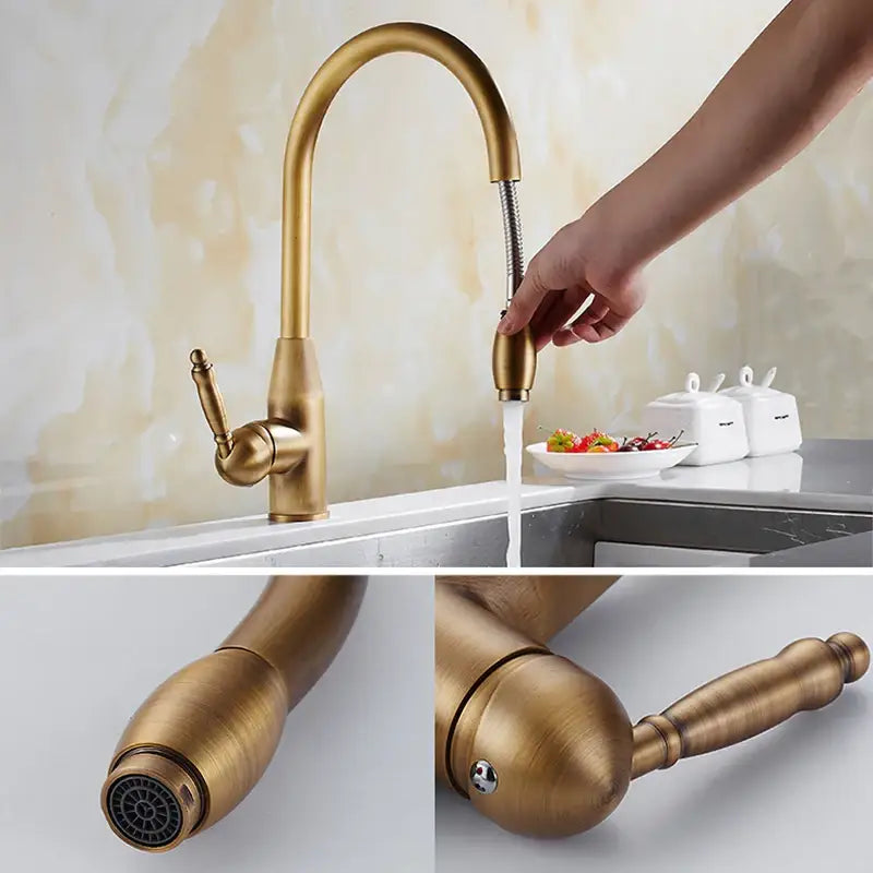 Antique brass and white ceramic kitchen faucet with brass-finished curved spout and pull-out spray head swivel mixer