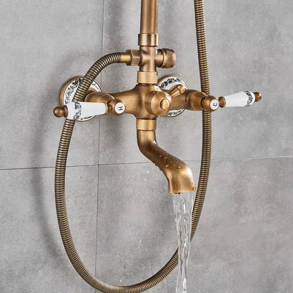 Antique brass and white ceramic shower faucet set with blue floral handles and flexible hose for bathroom use