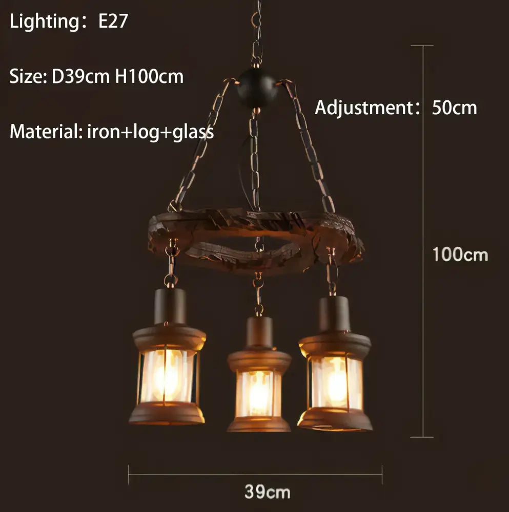 Rustic three-light pendant lights with dark iron and wood decorbites iron wheel frame and amber glass lanterns for dining rooms