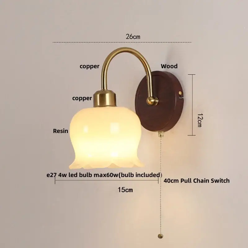 Antique brass and wood led wall light with warm translucent resin shade on dark wood backplate for bedroom decorbites led wall
