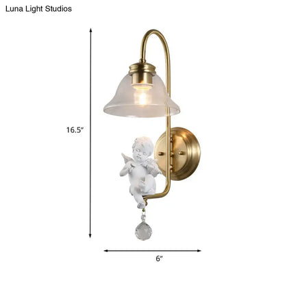 Antique brass glass sconce light featuring a white angel figurine with delicate wings and a clear glass droplet