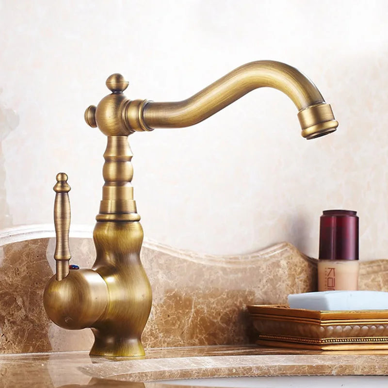Antique brass basin faucet with vintage style, ornate curved spout, and decorative handle in brass finish