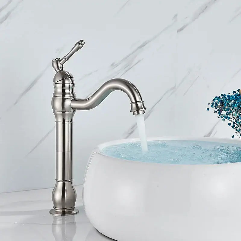 Stylish brass basin faucet with a single handle swivel spout and decorative brushed nickel ridged body for bathroom use