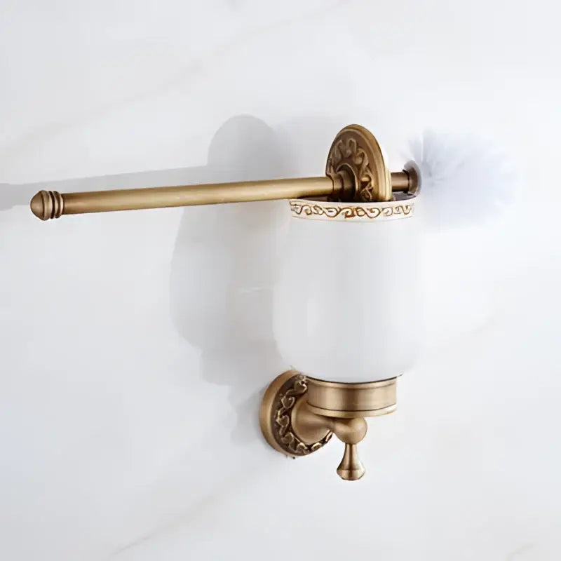 Antique brass bath hardware toilet brush holder with white ceramic cup and ornate decorbites brass antique detailing