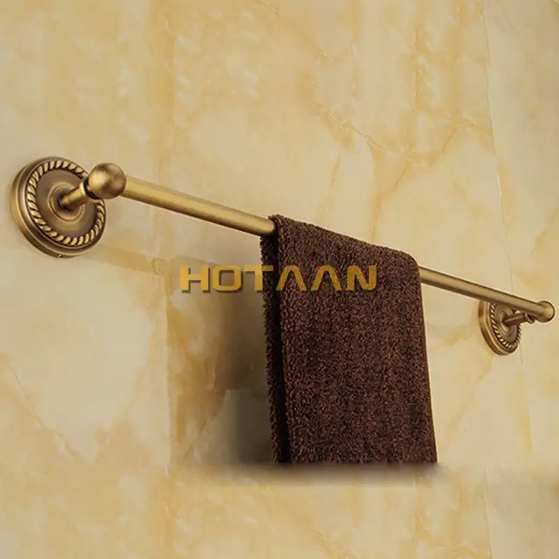 Antique brass towel rack with ornate rope twist detailing on wall mounted ends from decorbites brass bathroom set