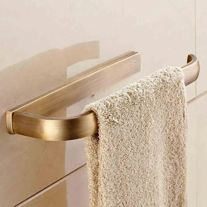 Brass-finished curved towel rack holding a beige textured towel from antique brass bathroom accessories set decorbites bathroom accessories