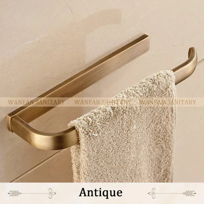 Antique brass bathroom accessories set towel rack with sleek curved design holding plush beige towel by decorbites brass bathroom