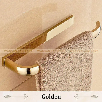 Golden metallic towel rack with sleek curved design holding beige towel from decorbites brass bathroom accessories set
