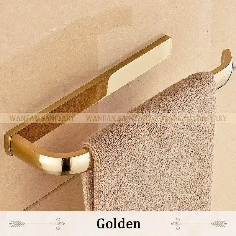 Golden metallic towel rack with sleek curved design holding beige towel from decorbites brass bathroom accessories set
