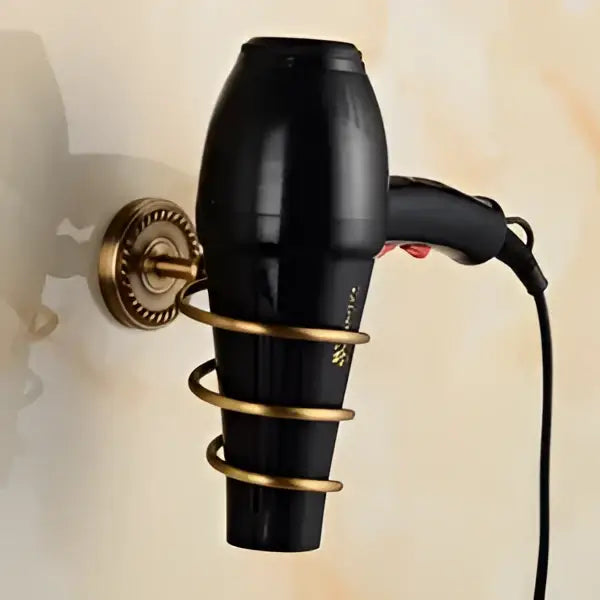 Antique brass bathroom set featuring a black hair dryer with gold-toned wall mount and spiral holder decorbites brass bathroom