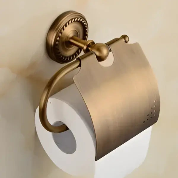 Antique brass toilet paper holder with ornate scrollwork and decorative cover from decorbites brass bathroom set