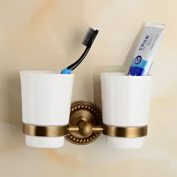 White ceramic toothbrush holder with gold-toned metal accents from decorbites brass bathroom ornate set