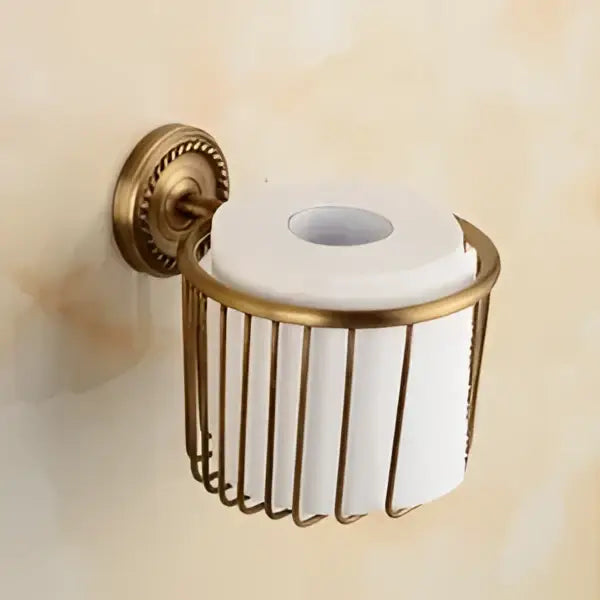 Antique brass bathroom set featuring a decorbites brass toilet paper holder with wire mesh design holding white roll
