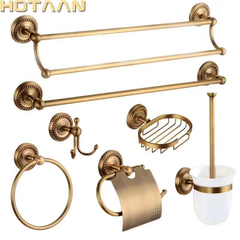 Antique brass bathroom set by decorbites featuring ornate circular mounts and a white ceramic brush cup with gold trim